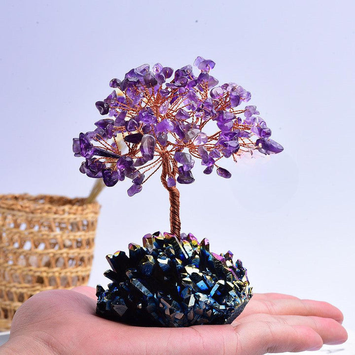 amethyst and rainbow crystal cluster bonsai tree on the hand