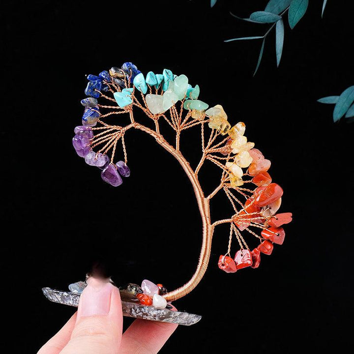 arc shaped rainbow crystal bonsai tree with agate base on the hand