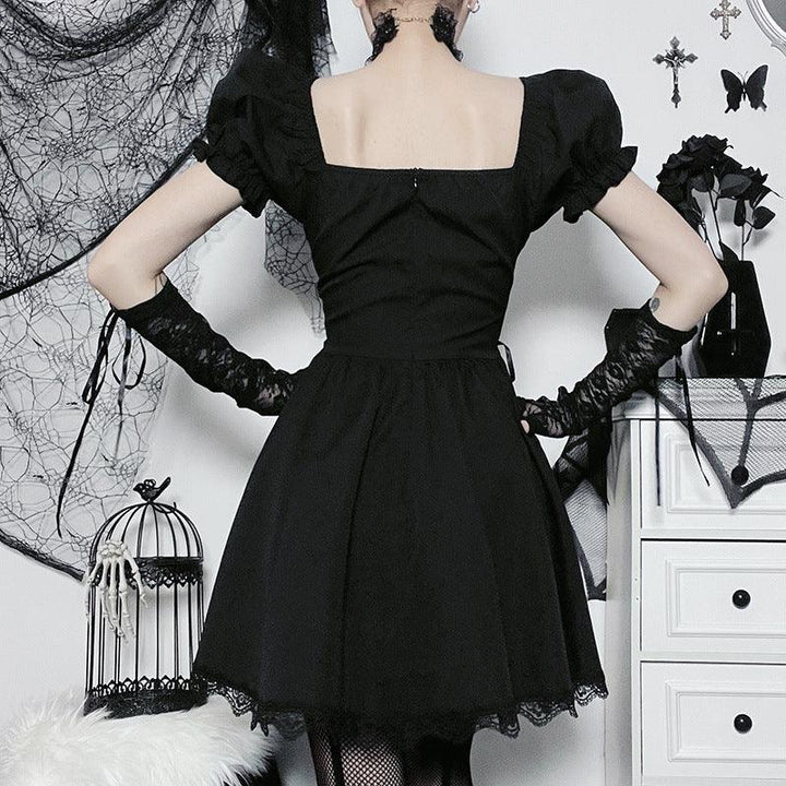 a woman wear a black gothic cross chain short lace dress