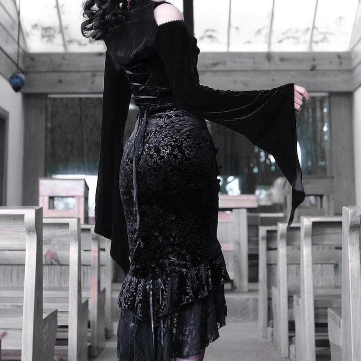 a woman wear a black gothic vampire half body long dress