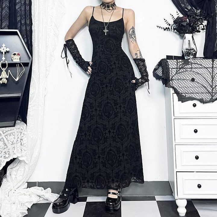 a woman wear a black gothic velvet spaghetti strap dress