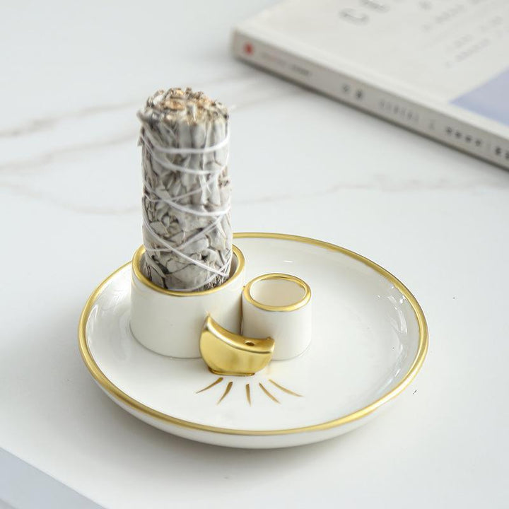 white and gold ceramic incense burner base burning tray on the table