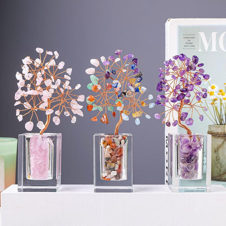 three crystal bonsai tree with transparent glass bottle base on the table