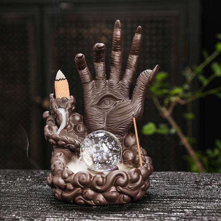 devils hand and eye with led light backflow incense burner holder on the table