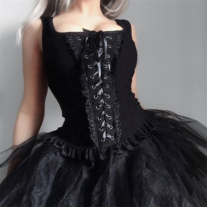 a woman wear a gothic punk strappy black sleeveless top vest