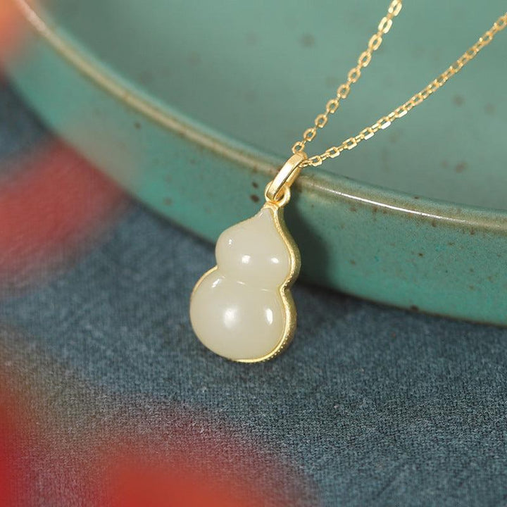 hetian green jade gourd pendant natural jade silver necklaces on the table