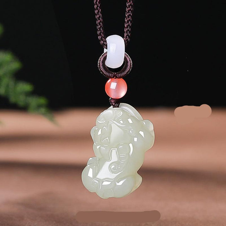 hetian jade pixiu pendant natural jade silver gold necklaces on the table