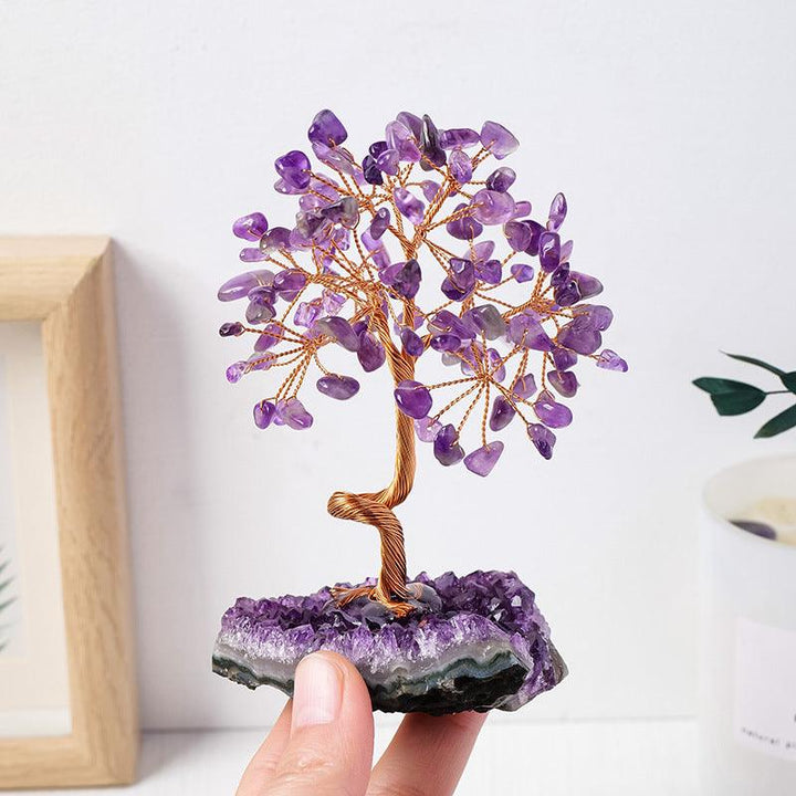 natural amethyst cluster crystal bonsai tree on the hand