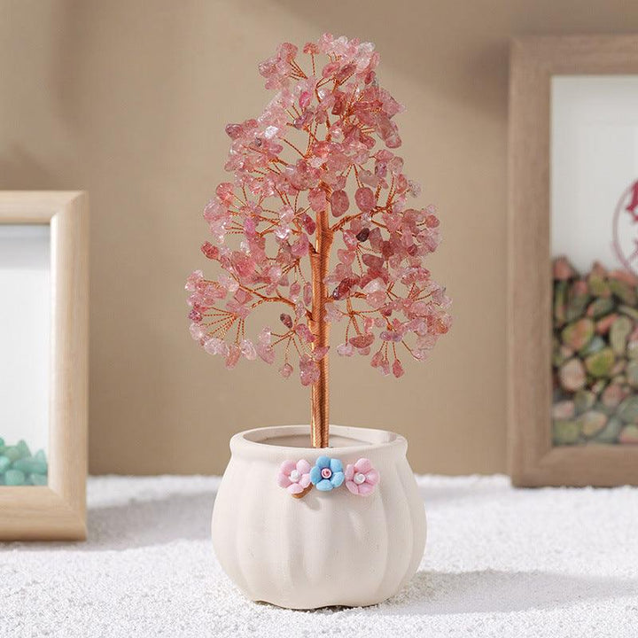 Strawberry quartz crystal bonsai tree with white flower pot base on the table