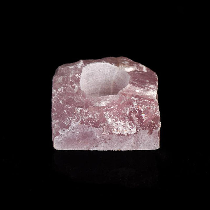 natural pink crystal raw stone candle holder on the table