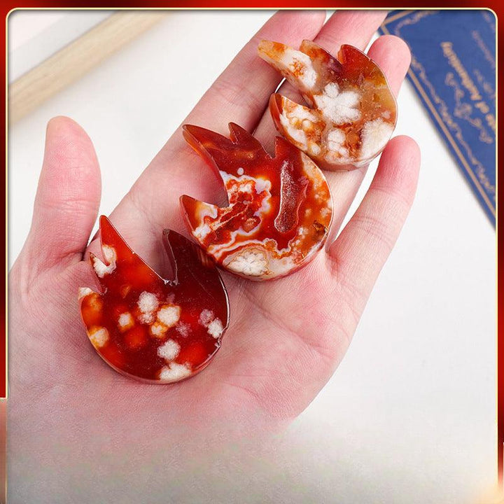 natural red agate flame carving home decor ornament on the hand