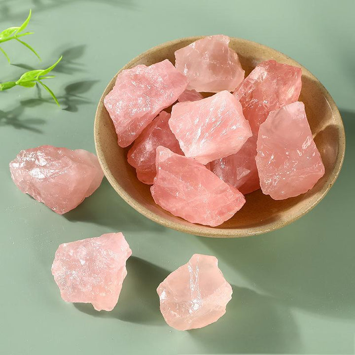 pink rose crystal raw stone natural gemstone on the table