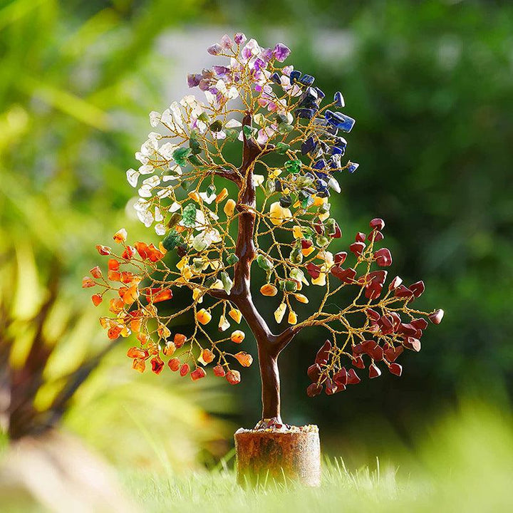 rainbow crystal bonsai tree with wooden base on the grass