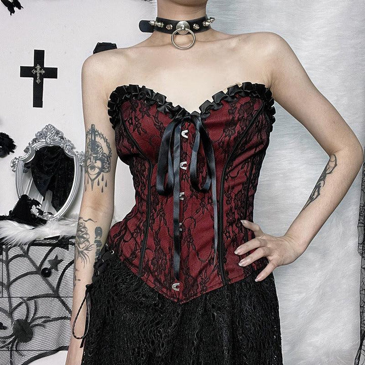 a woman wear a red and black gothic lace tie up top