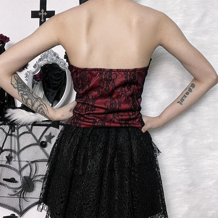 a woman wear a red and black gothic lace tie up top