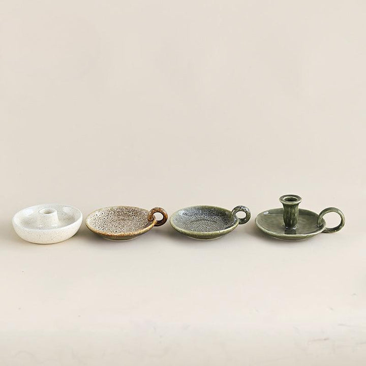 four vintage ceramic candlestick plate burning ornament on the table